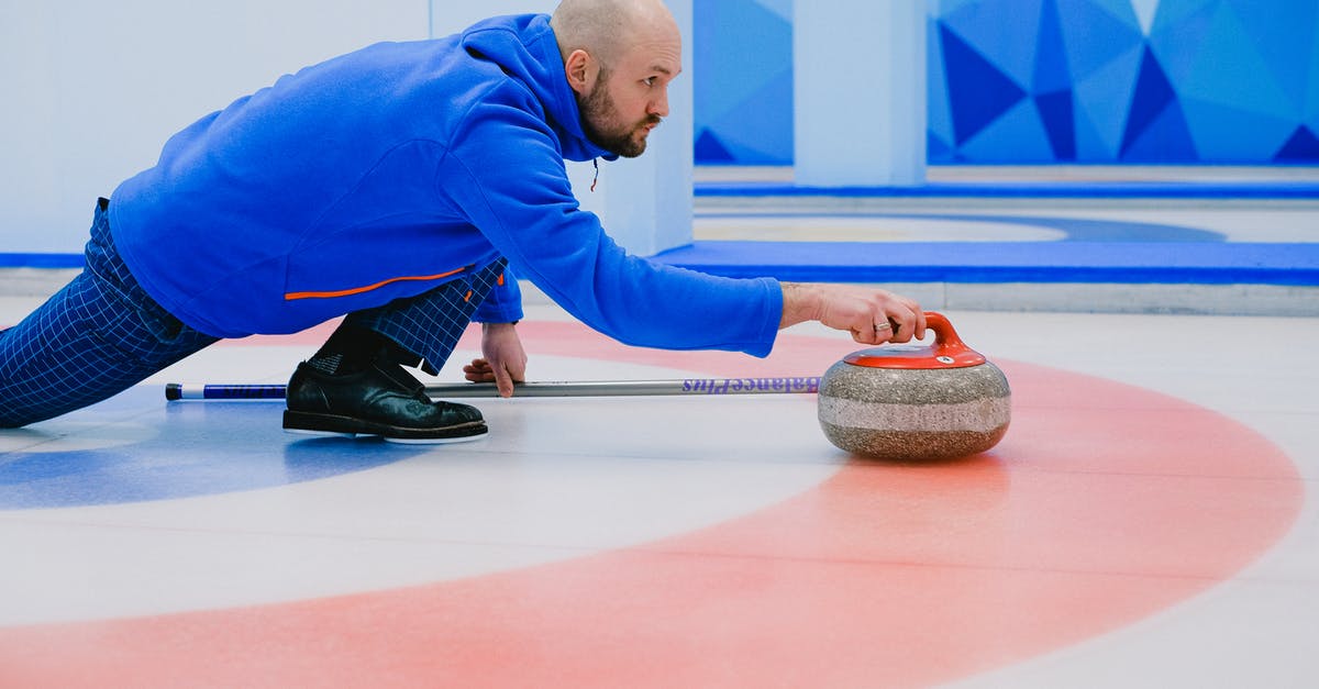 Is complimentary Wi-Fi available on ICE trains outside of Germany? - Side view of concentrated sportsman in activewear sliding on knee with stone in hand on ice rink during curling competition