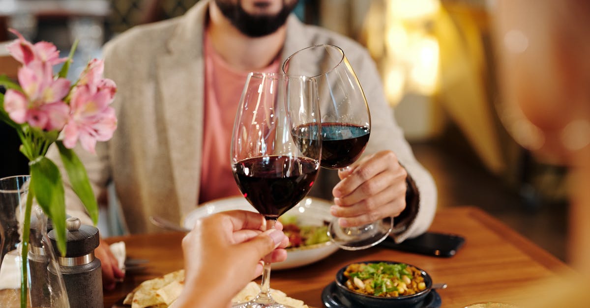 Is food in Rome's restaurants usually produced off-site then delivered? [closed] - Man in Gray Suit Holding Wine Glass