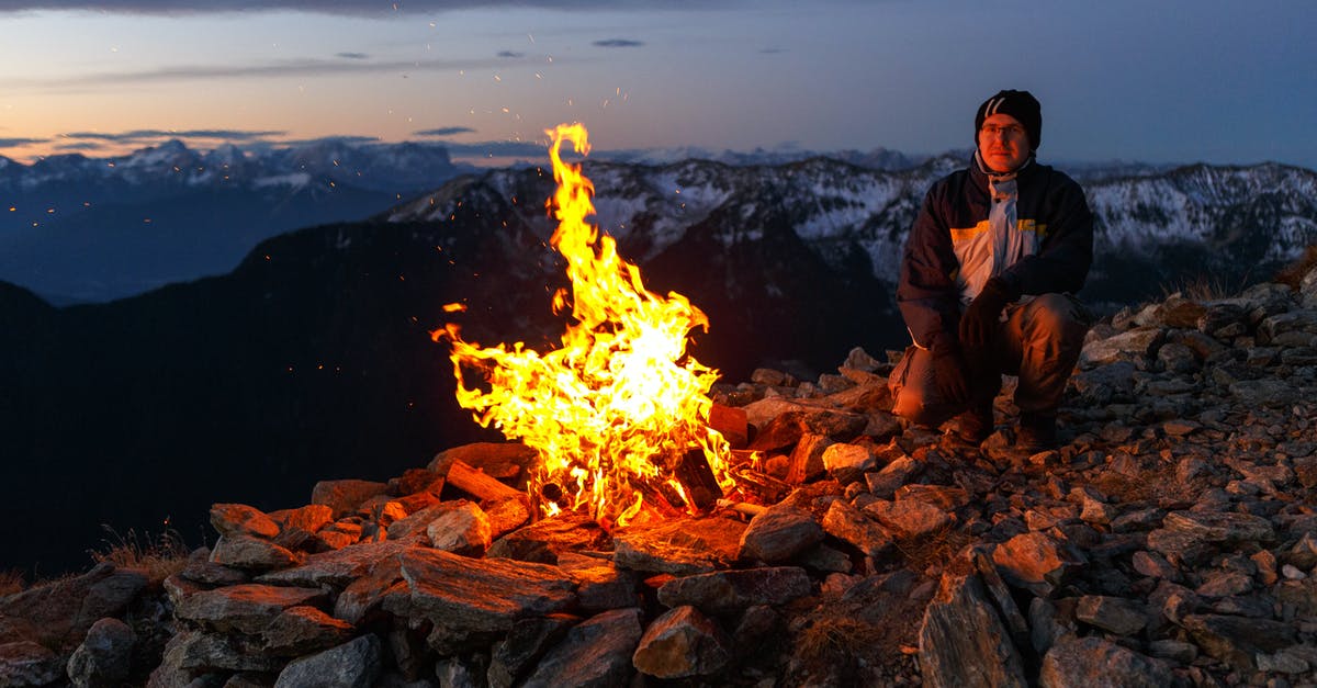 Is free camping permitted in Japan? - Person Wearing Brown Leather Boots Near Bonfire