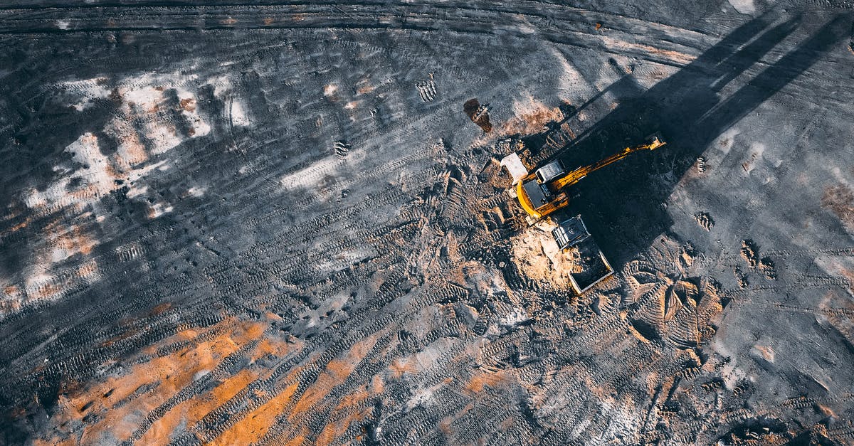 Is fuel dumping a peculiarity of American airlines? - Aerial view of excavator working on big coal field of powerplant located in countryside