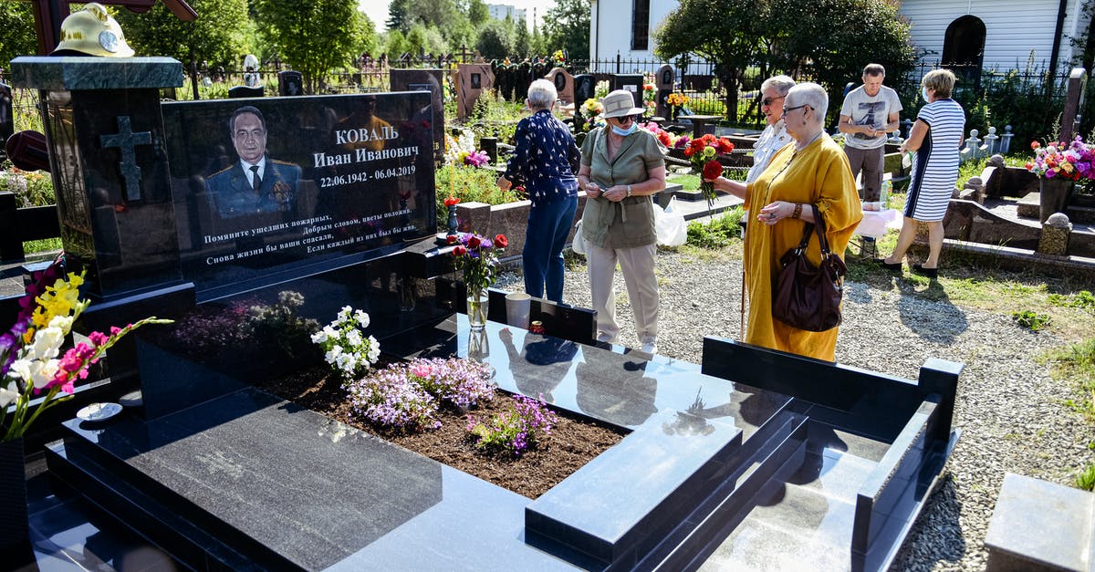 Is ID required for visiting the war cemeteries in Cowra? - People Standing Near Black and White Table