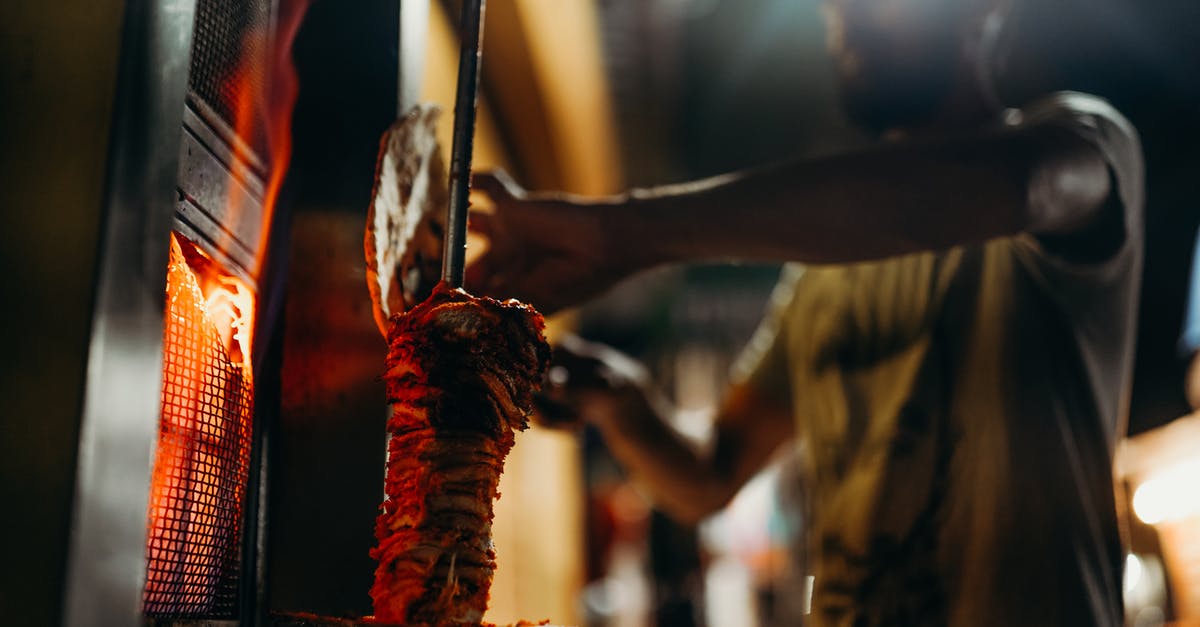 Is Indian food easily available in European countries? - Person in Red and Black Dress Holding Stick