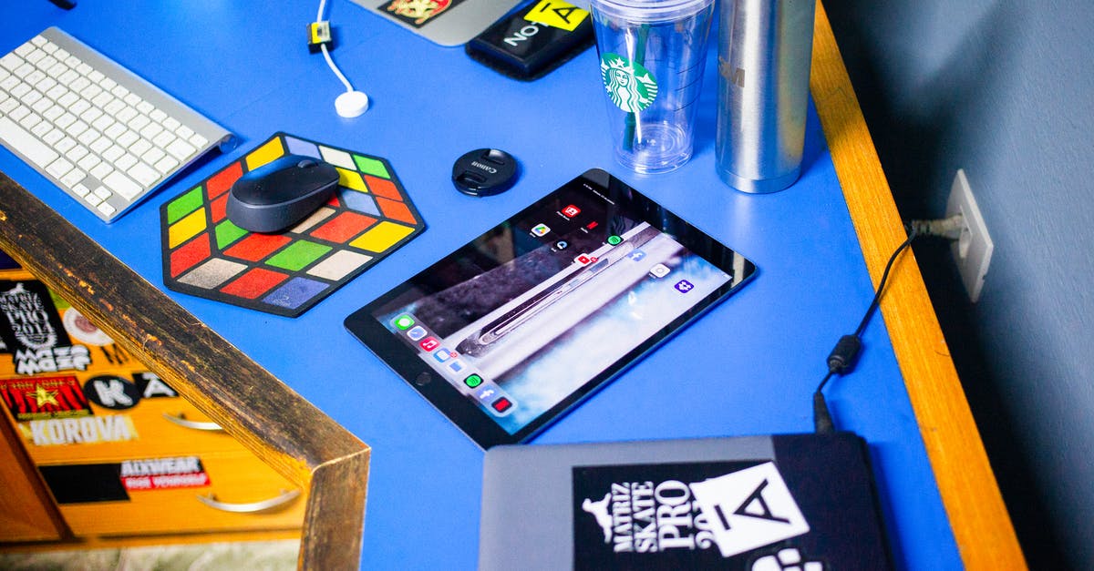 Is iPad counted as a second Laptop? [closed] - Ipad and Laptop on Blue Surface