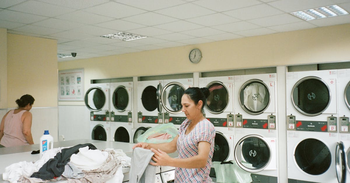 Is it a reasonable assumption that larger US hotels will have laundry facilities? - Photo of Woman Standing Inside the Laundromat