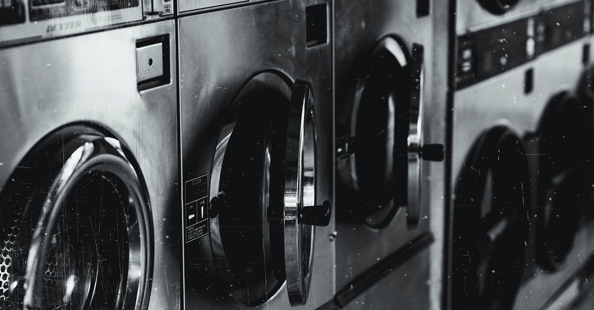 Is it a reasonable assumption that larger US hotels will have laundry facilities? - Grayscale Photo of Washing Machine