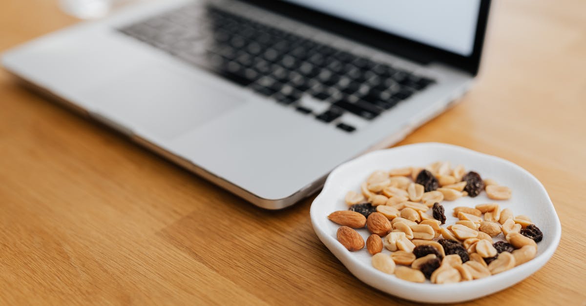 Is it allowed to bring nuts and raisins to Colombia? - Macbook Pro on Brown Wooden Table