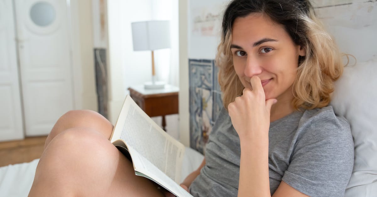 Is it always wise to book flights as soon as possible? - Woman in Gray Shirt Sitting on Bed