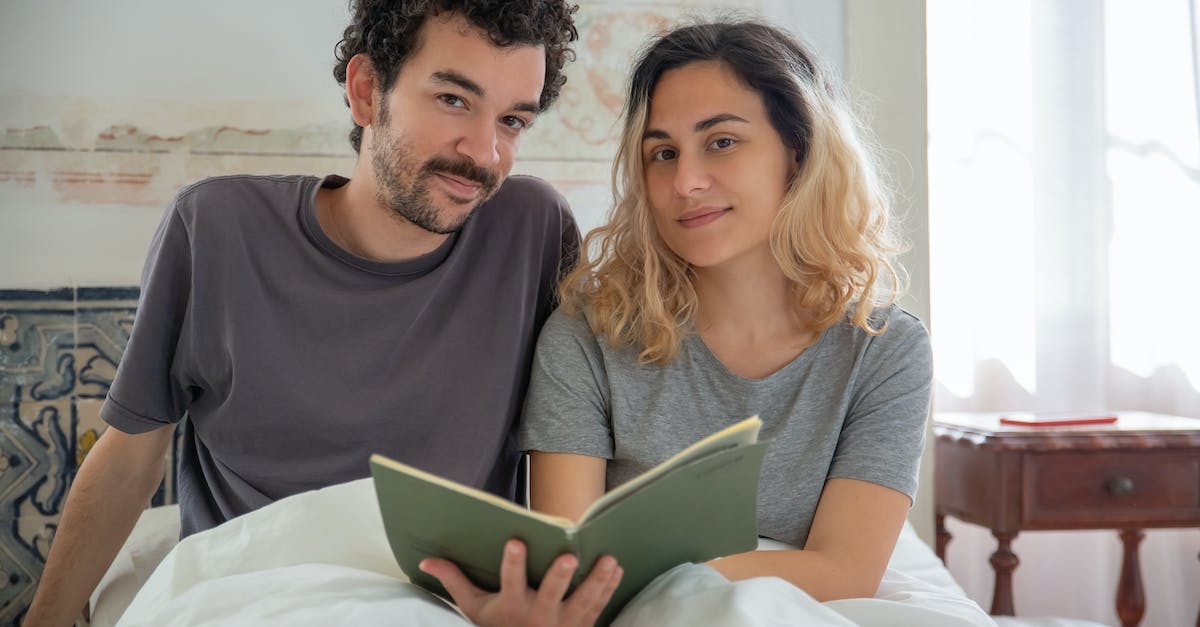 Is it always wise to book flights as soon as possible? - Man in Gray Crew Neck Shirt Beside Woman in Gray Scoop Neck Shirt