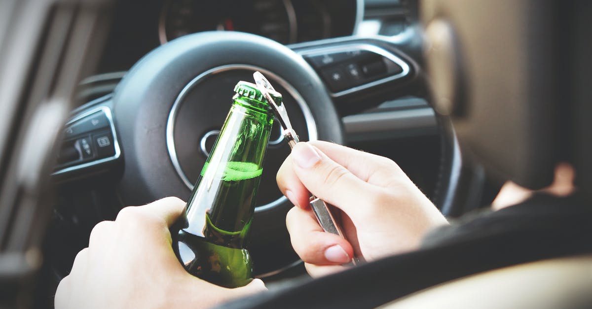 Is it dangerous to drive through Death Valley? - Person Opening Bottle on Car