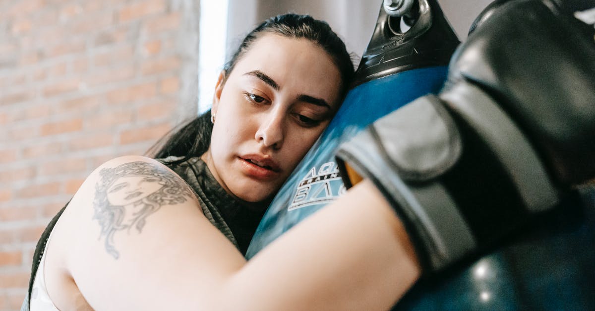 Is it difficult to get a C1 visa from Ghana? [closed] - Low angle side view of exhausted young female in boxing gloves having pause in hard training in fitness center