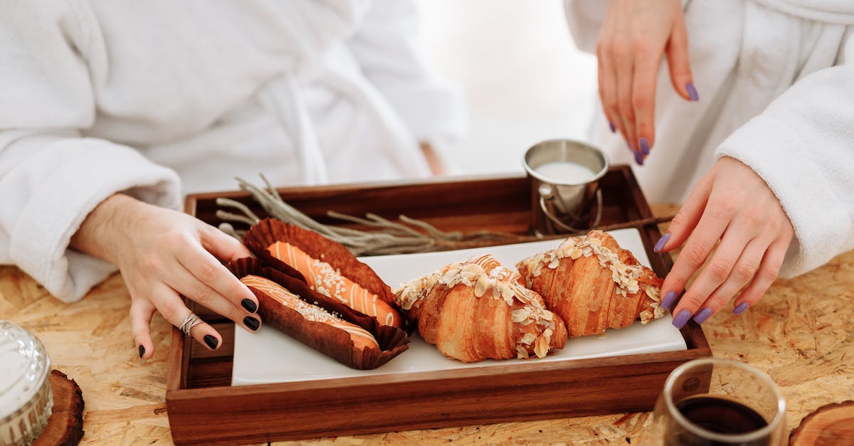 Is it easy to find milk in Laos? - Person Holding Bread on Brown Wooden Tray