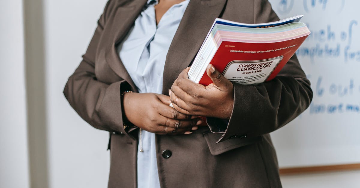 Is it necessary to book OBB Rex trains in advance? - Anonymous black female tutor with books standing near whiteboard at school