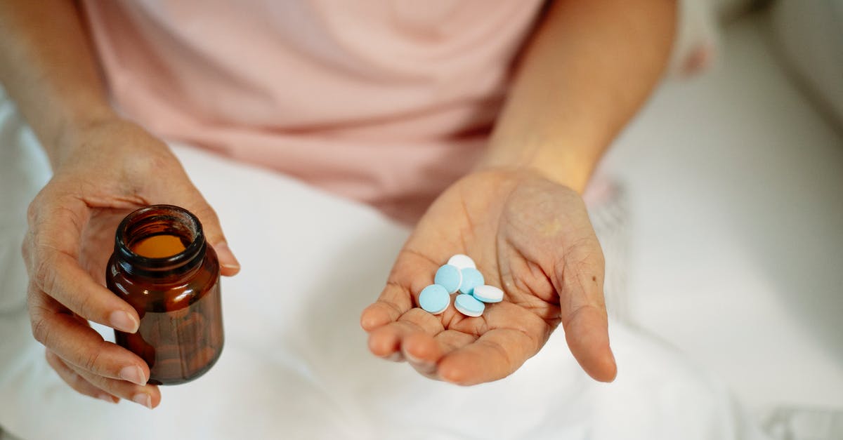 Is it necessary to take Malaria medication in Laos? [duplicate] - Person holding pills in hand while sitting on bed