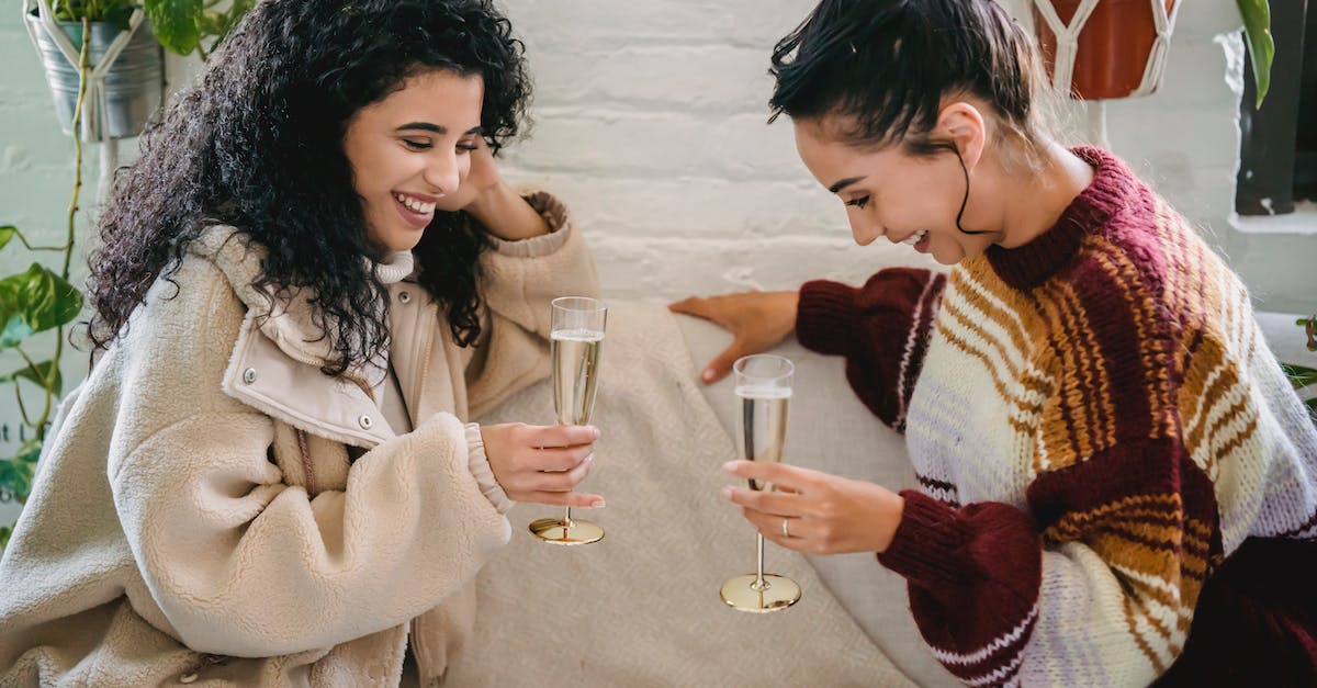 Is it normal to have something added to the bill in a restaurant in Italy? - Young happy Hispanic female friends with glasses of champagne having fun sitting on sofa and celebrating holiday Is it normal to have something added to the bill in a restaurant in Italy? - Young happy Hispanic female friends with glasses of champagne having fun sitting on sofa and celebrating holiday