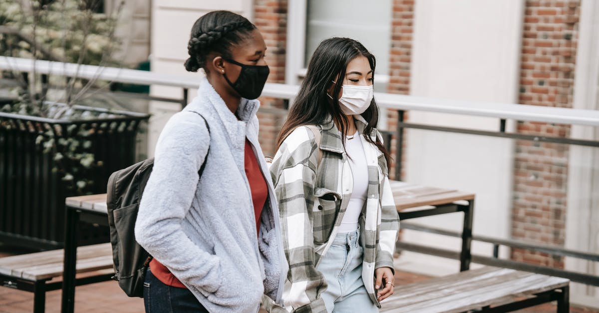 Is it normal to walk around an (American) hotel in pajamas? - Diverse students walking near table in campus