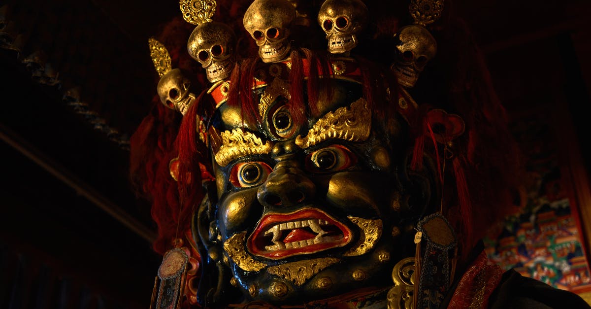 Is it ok to provide match tickets from third party sites - From below of Tsam mystery mask with gilded human face and third eye and pig nose and fangs among teeth and golden circles around face and full head of red hair decorated with red hairband adorned with golden skulls