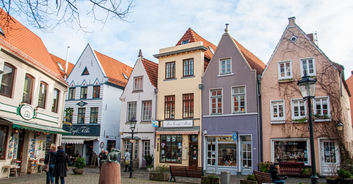 Is it okay to arrive in Europe with less than 400EUR? - Brown and White Concrete Building Near Bare Trees