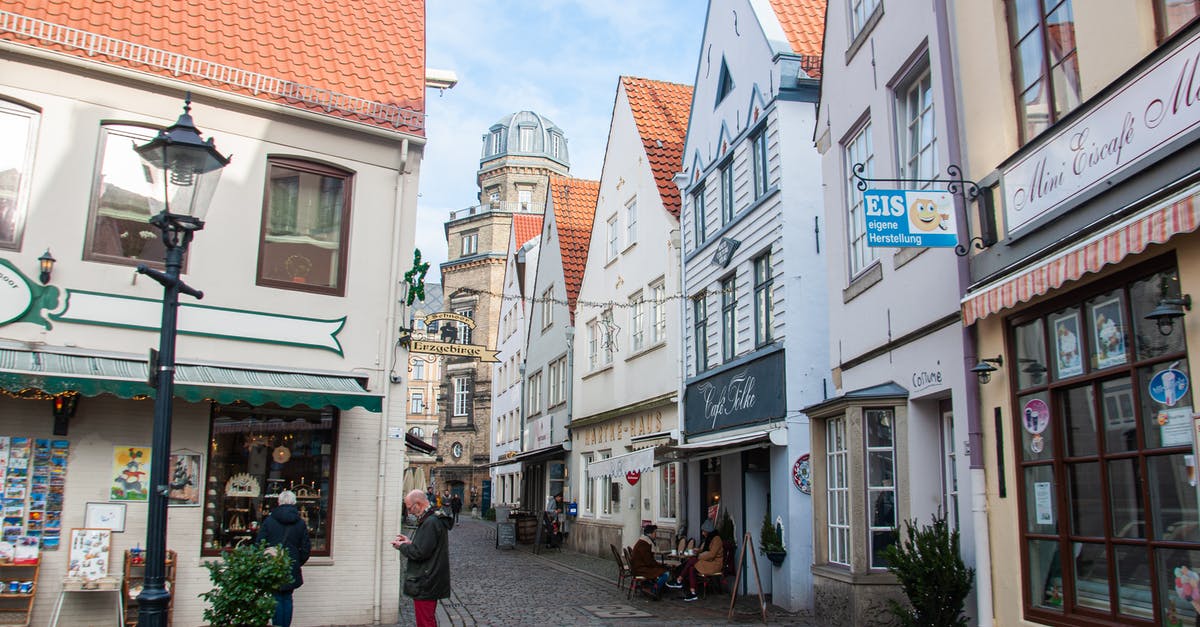 Is it okay to arrive in Europe with less than 400EUR? - People Walking on Street Near Buildings