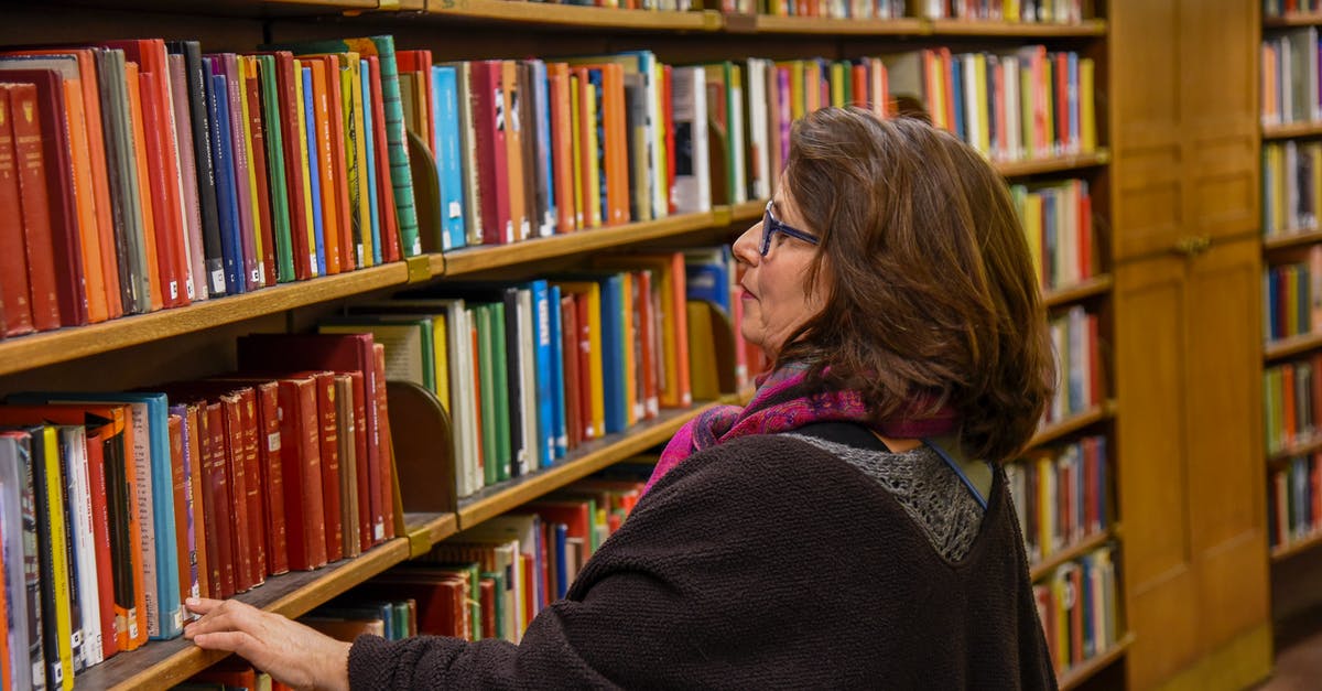 Is it possible to aggregate different hotel bookings in one search? - Woman choosing book in public library