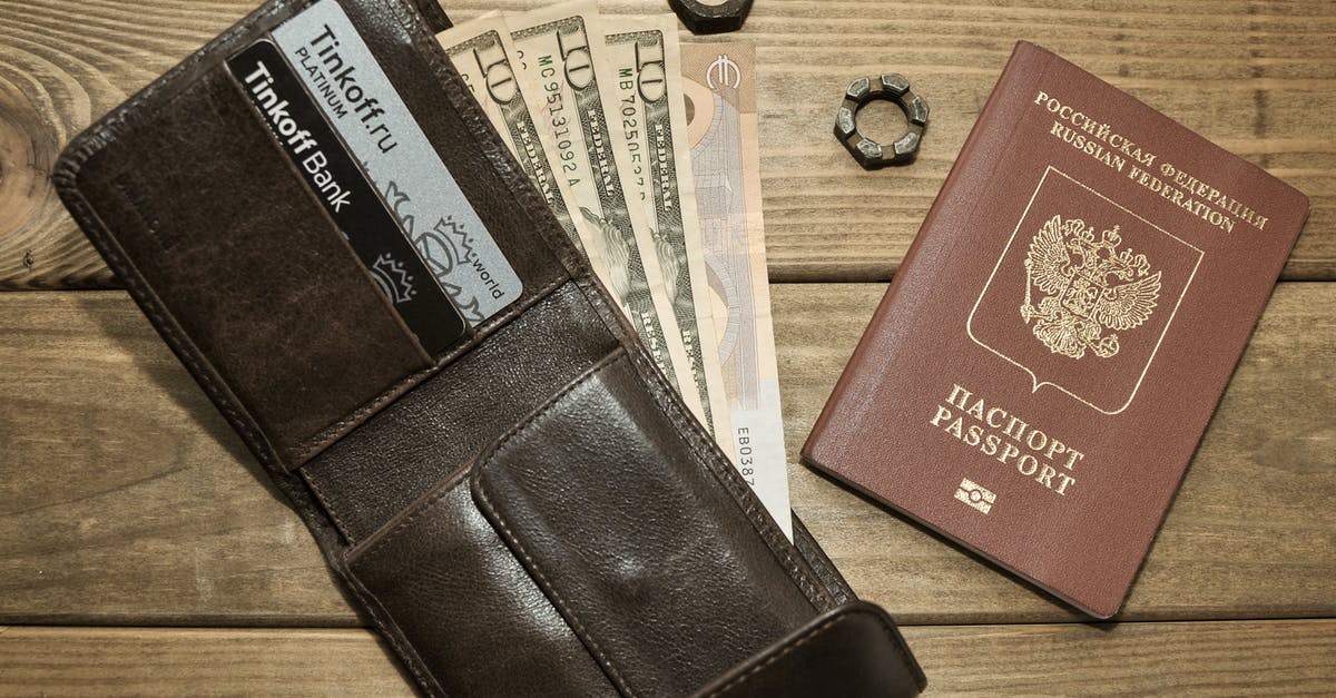 Is it possible to apply for Russian passport by mail/internet in North America? - Photograph of a Leather Wallet with Dollar Bills Beside a Passport