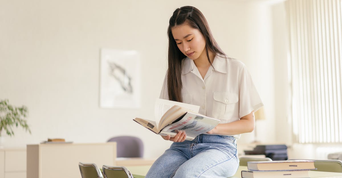 Is it possible to book adjacent seats on a NightJet train? - A Pretty Girl in White Polo Shirt Sitting on Table Reading a Book