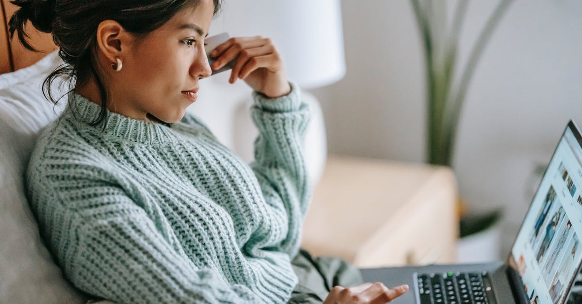 Is it possible to buy unlimited 3G/4G internet in Italy? - Side view of crop concentrated young ethnic female using touchpad of netbook and shopping online