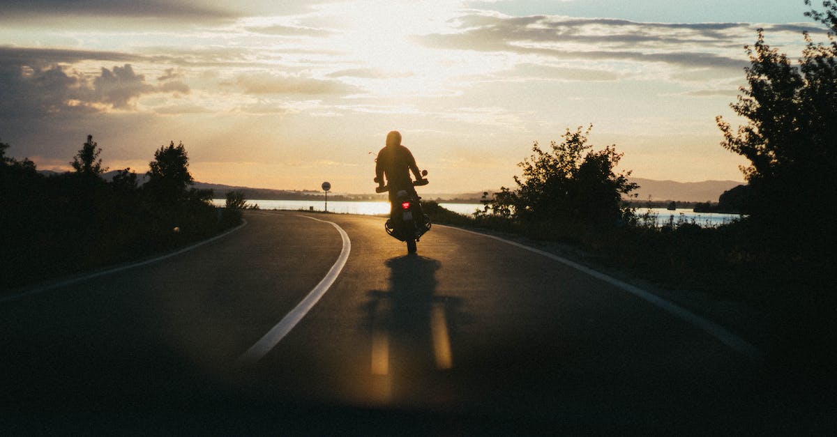 Is it possible to drive your own motorbike in/around Siem Reap? - Person Riding Motorcycle during Golden Hour