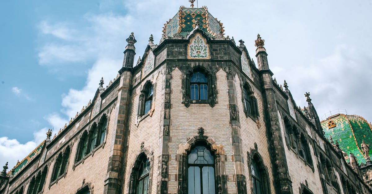 Is it possible to enter Hungary from Serbia? - Low angle of old stone building facade with arched windows and ornamental walls in Hungary