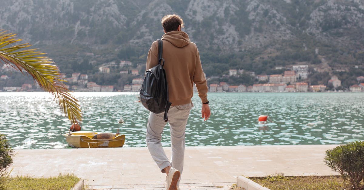 Is it possible to get a Canadian visa without concrete plans? - Man in Brown Hoodie Walking Near Water