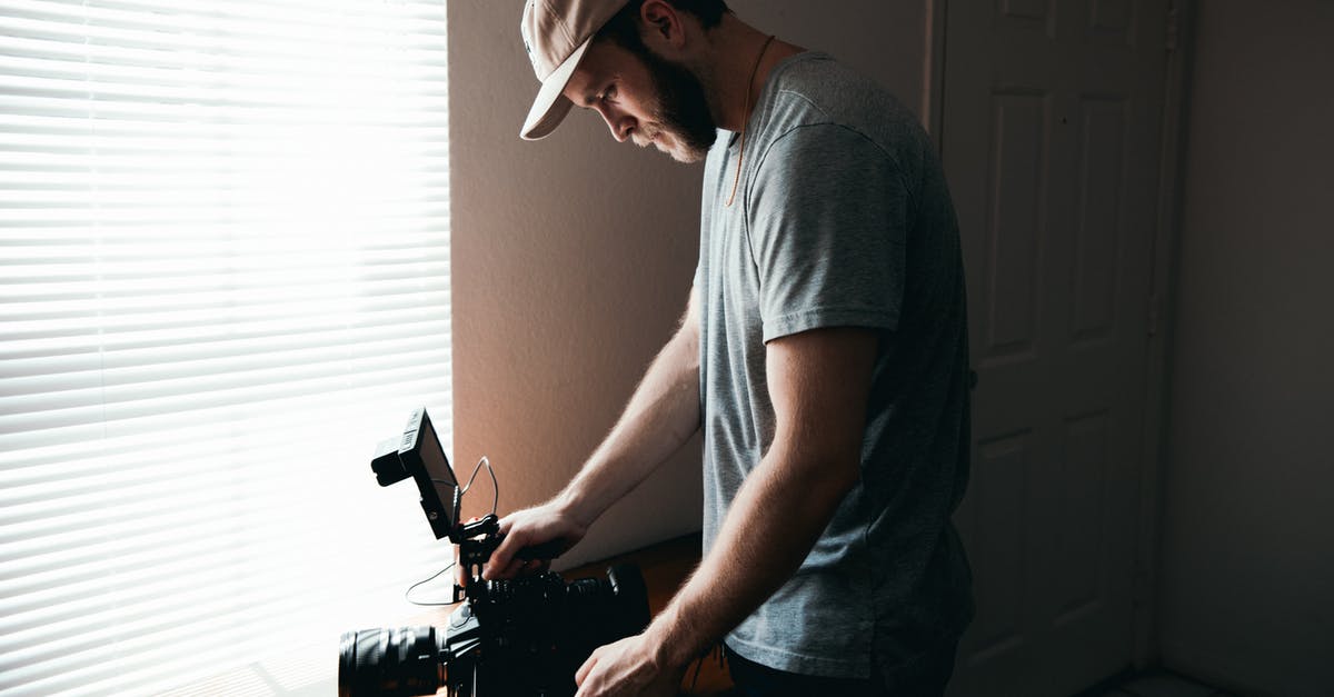 Is it possible to hire a tour guy through Iraq with a film crew for a documentary film on Iraq ancient history? - Man in Gray Crew Neck T-shirt and Gray Cap Holding Black Video Camera Is it possible to hire a tour guy through Iraq with a film crew for a documentary film on Iraq ancient history? - Man in Gray Crew Neck T-shirt and Gray Cap Holding Black Video Camera