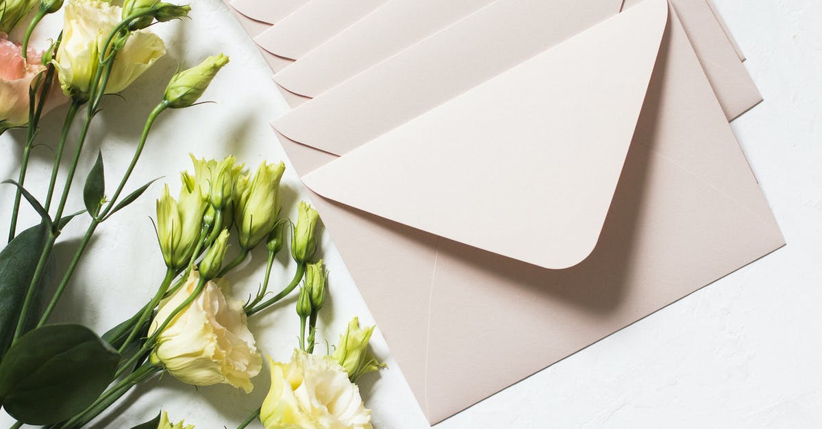 Is it possible to send a letter from LAX airport while in transit there? - From above of rows of light beige envelopes by white and pink delicate roses on stems with dark green leaves in daylight