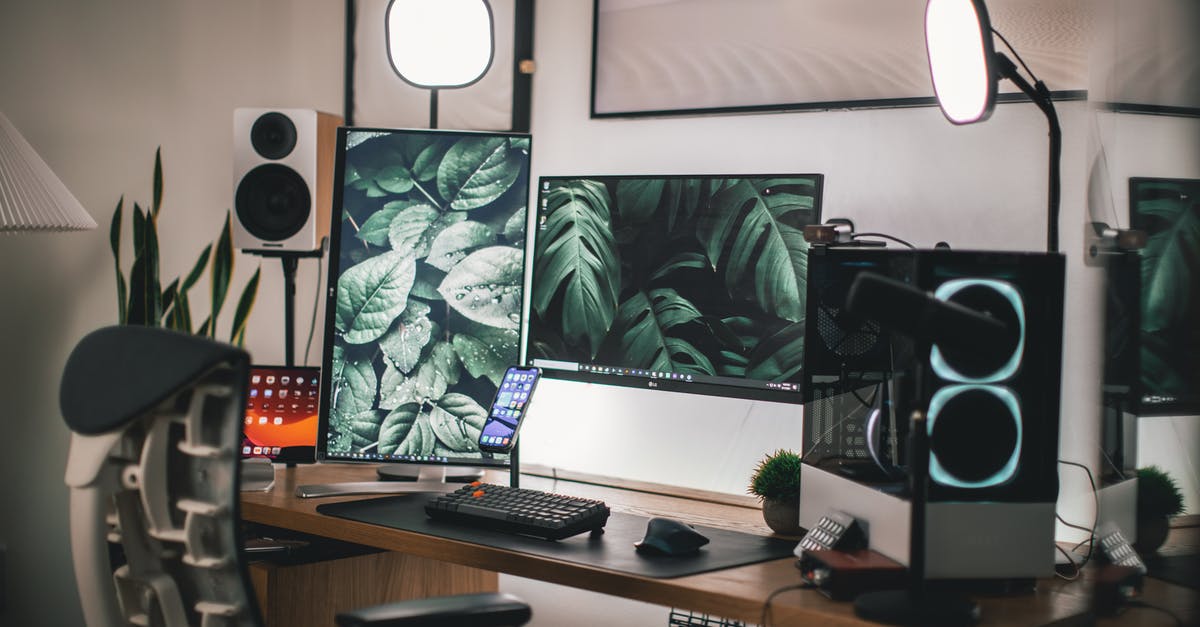 Is it rude to give up your seat in Japan? - Black Flat Screen Computer Monitor on White Wooden Desk