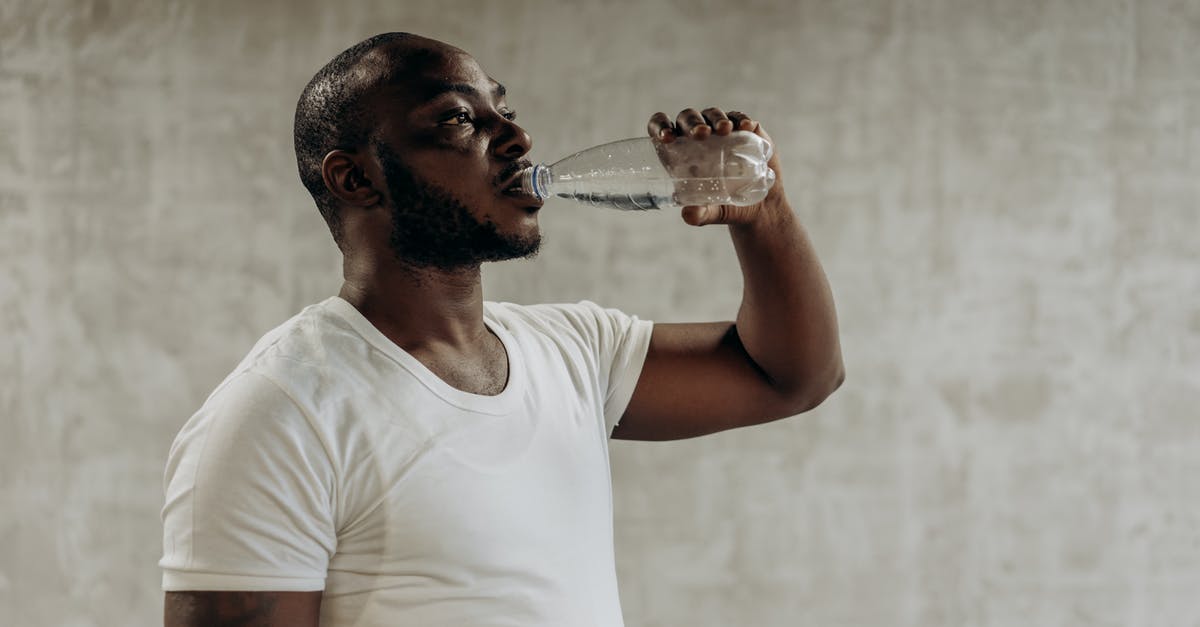 Is it safe to drink water with a strong chlorine smell? - Man Drinking A Bottle Of Water