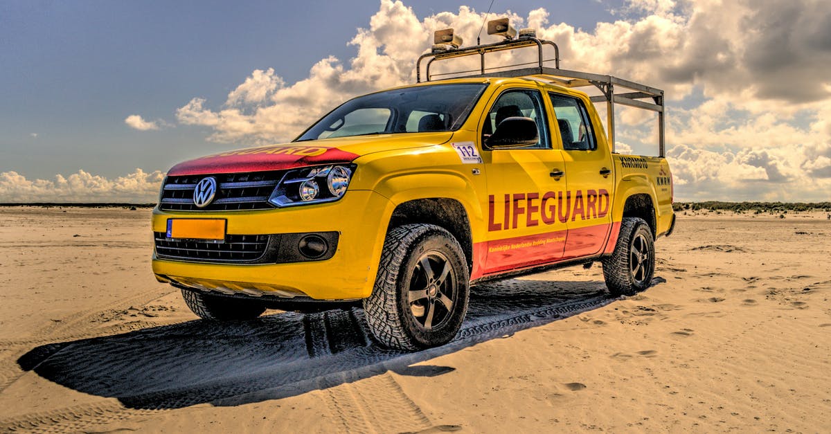 Is it safe to swim at Clifton Beach, Pakistan? - Yellow and Red Pickup Truck on Sand