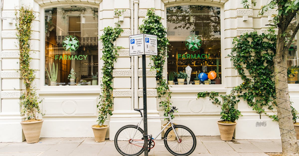 Is it safe to travel by bike between cities in Spain? - Black and White Bicycle Beside Post