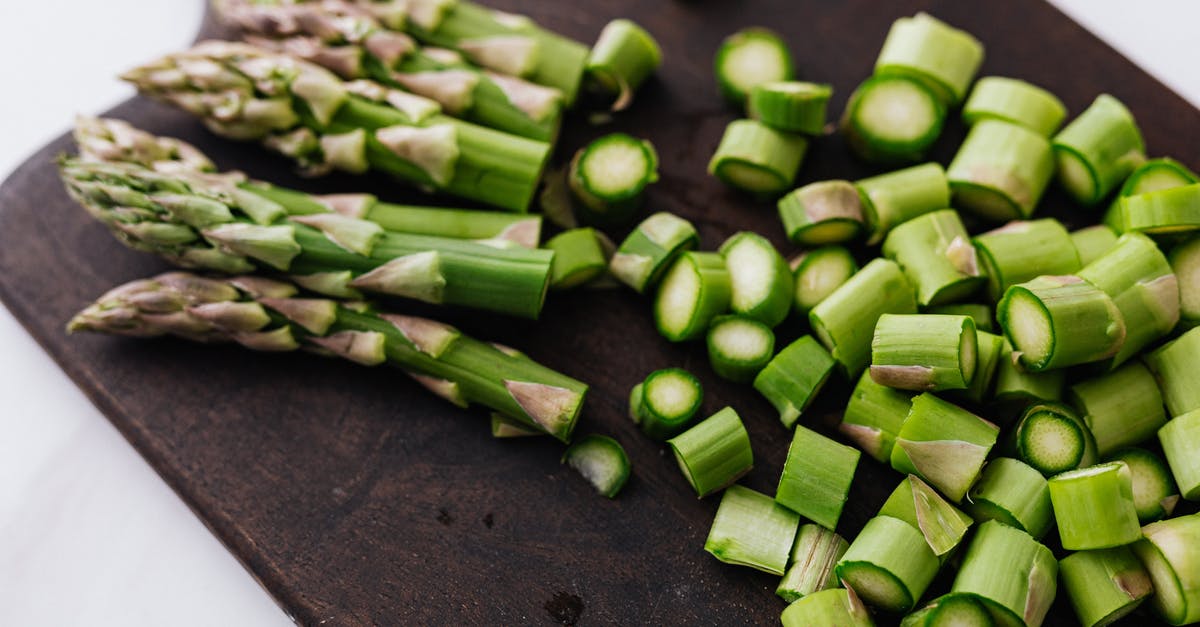 Is it still necessary to pre-request a vegetarian meal on intercontinental flights? [closed] - Closeup of green chopped stems of asparagus placed on wooden cutting board on white surface