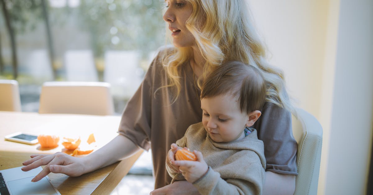 Is it the carrier's responsibility to bringing a passenger home? - Photo Of Woman Carrying Her Baby While Working On Her Laptop