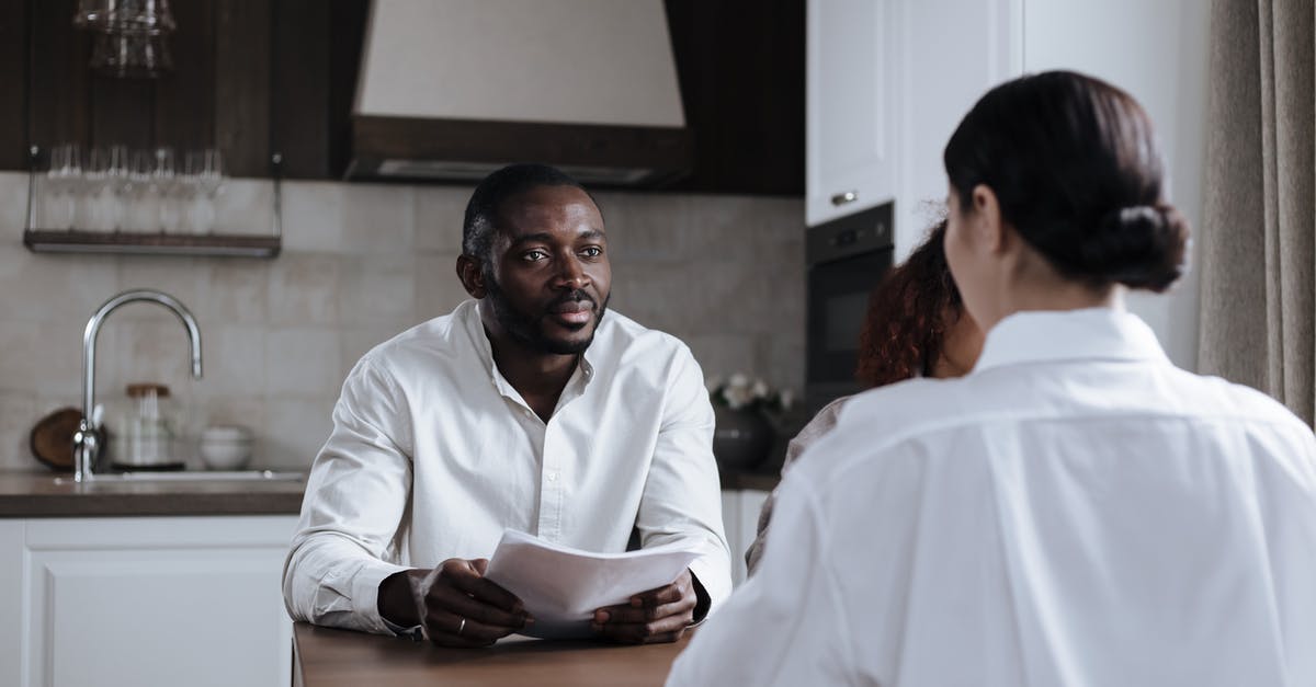 Is it the carrier's responsibility to bringing a passenger home? - Afro-American Man and Caucasian Woman Having Meeting at Home with Social Worker