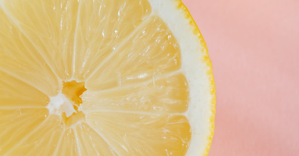 Is it true that random scanning at Airports require passenger to be half naked? [closed] - Closeup of slice of fresh juicy bright lemon placed on smooth pink surface