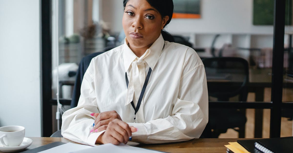 Is Jat Airways reliable? - Serious black businesswoman sitting at desk in office