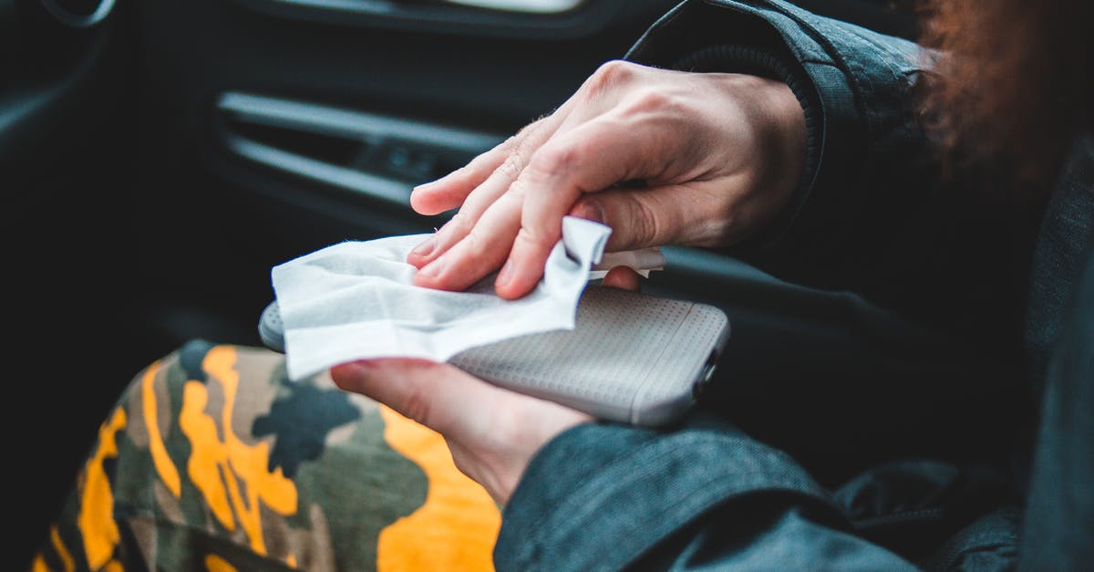 Is Portugal open to travel from Brazil and vice versa, by plane? Covid problems? - Crop person wiping smartphone with napkin