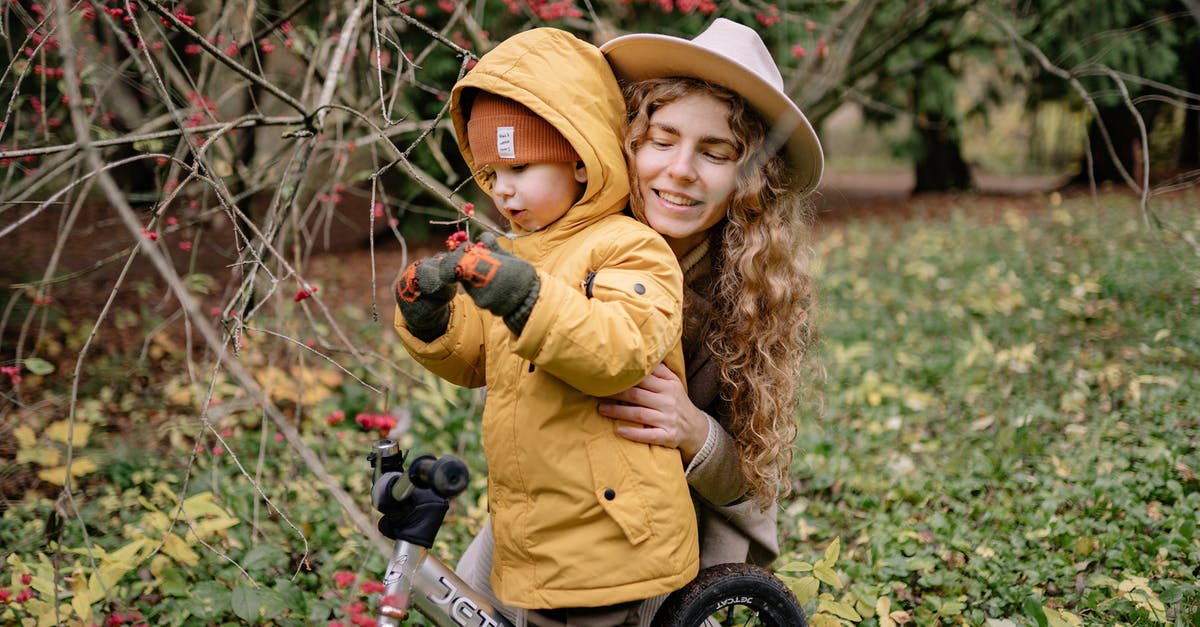 Is riding a bicycle in the parks of Glasgow allowed? - Girl in Yellow Jacket Riding on Bicycle