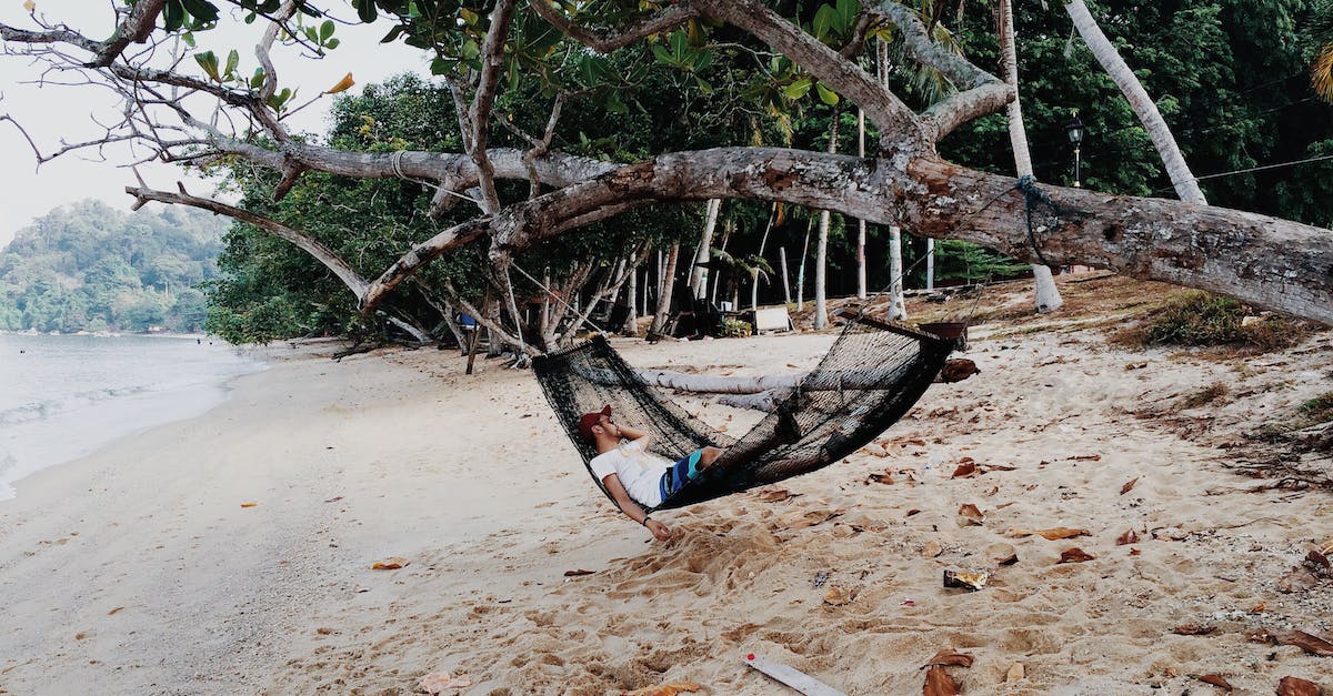 Is sleeping in tents / hammocks allowed in Malaysian beaches? - A Man Sleeping on a Hammock