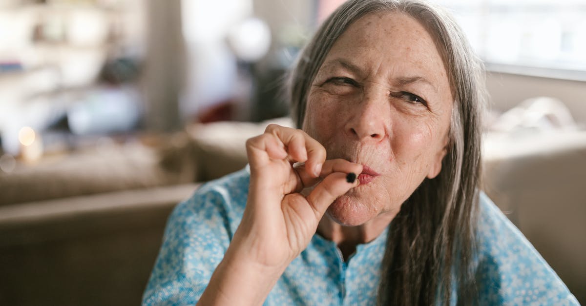 Is smoking weed legal or just tolerated in Colorado? - Woman in Blue Shirt Smoking Medical Marijuana