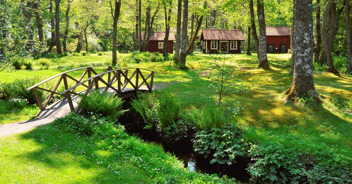 Is Sweden full of mosquitoes during the summer? - Brown Wooden House Near the Creek With a Bridge