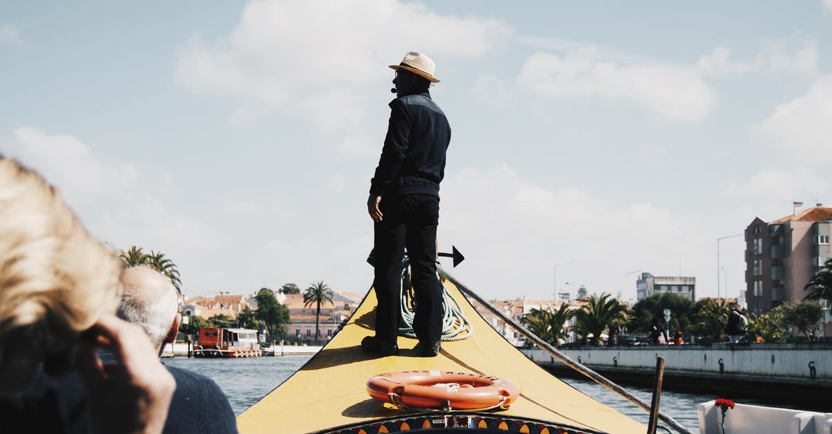 Is the Buffalo River at King Williams Town navigable by boat? - Black man standing on tourists boat front