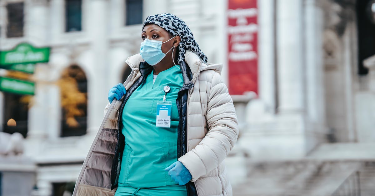 Is the road from Delhi to Nepal Safe? - Black woman in doctor uniform crossing street