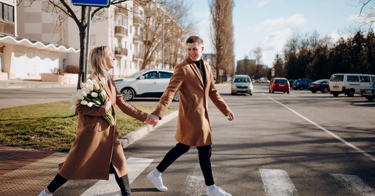 Is the San Ysidro PedWest crossing closed? - A Couple in Trench Coats Crossing the Road