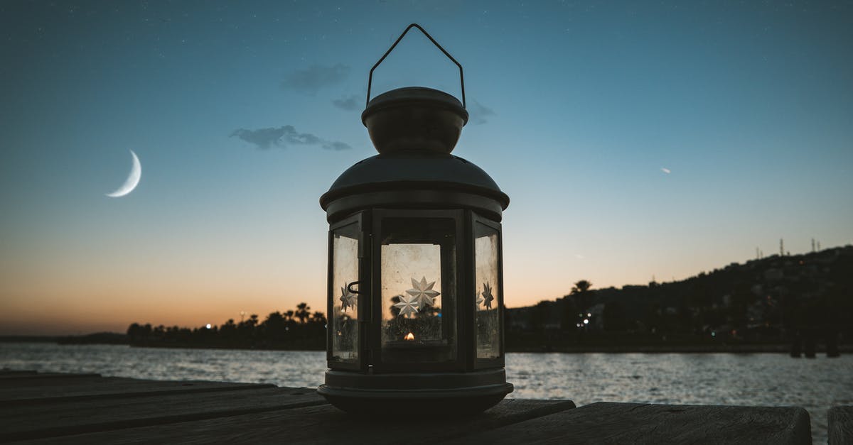 Is the Sea of Stars real? - Gray Metal Candle Lantern on Boat Dock