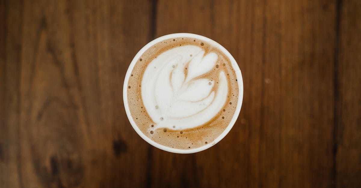 Is the Sudbury Slag Pour still a thing? - Top view of cup of aromatic cappuccino in ceramic cup with white foam poured in form of plant on brown surface